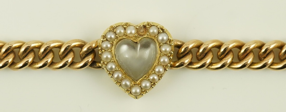 A late Victorian 15ct gold curb link bracelet, with central moonstone and seed pearl set heart shaped motif